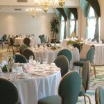 banquet room with green chairs and white table cloths at Best Western Plus The Inn at Hampton