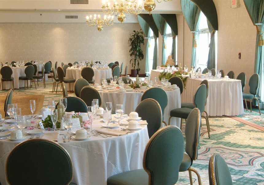 banquet room with green chairs and white table cloths at Best Western Plus The Inn at Hampton